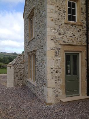 new carved Ham hill stone window surround & Bath stone chisel dressed quoins.